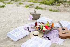 Picnic on the beach at sunset in the style of boho photo