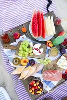 Picnic on the beach at sunset in the style of boho photo