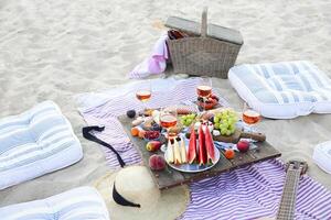Picnic on the beach at sunset in the style of boho photo