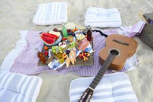 Picnic on the beach at sunset in the style of boho photo