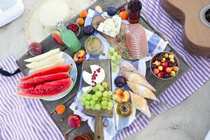 Picnic on the beach at sunset in the style of boho photo