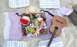 Picnic on the beach at sunset in the style of boho photo