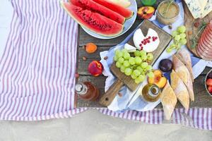 Picnic on the beach at sunset in the style of boho photo