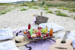 Picnic on the beach at sunset in the style of boho photo