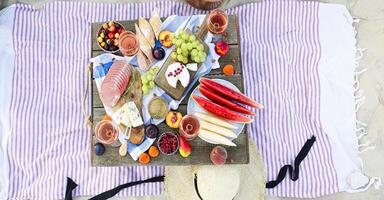 Picnic on the beach at sunset in the style of boho photo