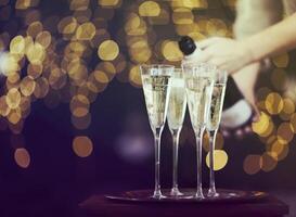 Champagne glasses on lights background photo