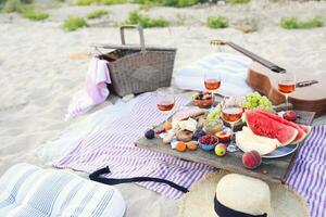 Picnic on the beach at sunset in the style of boho photo