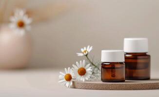 Chamomile Essential Oil Bottles on Wooden Coaster photo