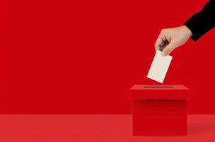 Hand Dropping Ballot Into Red Box photo