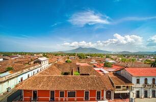 View of the tiled roofs of the colorful buildings in Granada, Nicaragua. Top view of the facade of colorful colonial buildings in the city of Granada photo