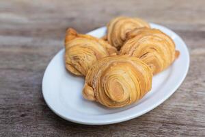 Curry puffs are a snack of Central in Thailand. It is a small pie that contains chicken and potatoes in a deep fried pastry shell. photo