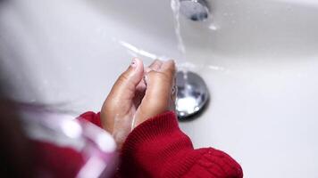 child making a cleansing gesture with soap and water on hands video