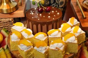 a table with a cake, fruit, and a chocolate bar photo
