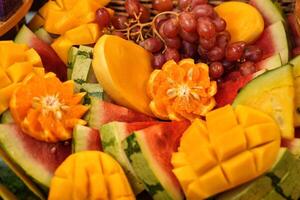 a plate of fruit with grapes, watermelon, and melon photo