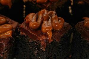 a close up of a piece of chocolate cake with caramel frosting photo