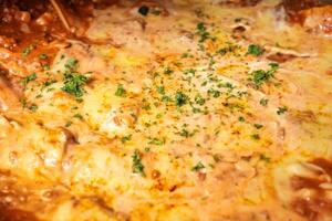 a casserole dish with cheese and sauce on top photo