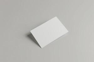 Blank white business cards isolated on grey background. photo