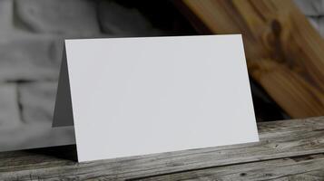Blank white business card on a wooden table. photo