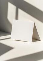 Blank card mockup on a white background with shadow from the window photo