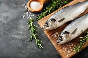 Fresh Fish On Cutting Board With Rosemary photo