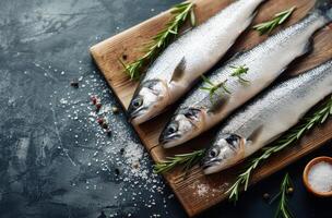 Fresh Fish On Cutting Board With Rosemary photo
