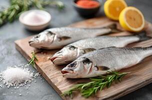 Fresh Fish On Cutting Board With Rosemary photo