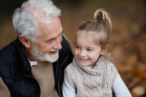 Grandfather and Granddaughter Laugh in Autumn photo