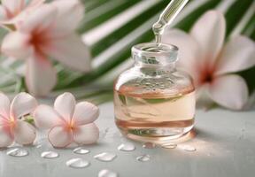 Essential Oil Dropper With Plumeria Flowers photo