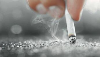 Closeup of a Cigarette Being Held and Smoked photo
