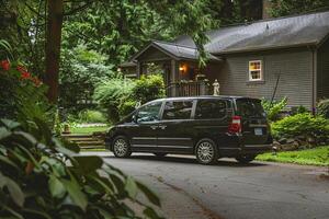 Minivan Parked in Suburban Driveway with nature background photo