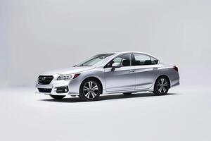 Mid size sedan photographed against white  in  studio ing on its fuel efficiency and environmental features background photo