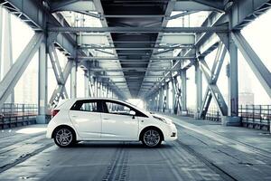 Subcompact hatchback in modern industrial setting with steel beams and  diffused lighting background photo