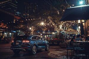 Luxury crossover parked at highend urban restaurant with diners seated at outdoor tables and city lights twinkling in the background photo