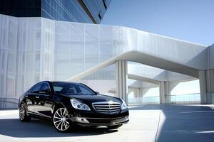 Luxury Full size sedan parked in an upscale urban environment with white architectural elements and background photo