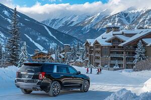 Luxury Mid size SUV parked at luxury ski resort with skiers coming down snow covered slopes and cozy lodge in the background photo