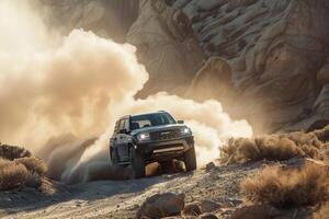 Full size crossover driving on challenging off road trail with rugged terrain and dust clouds trailing behind photo