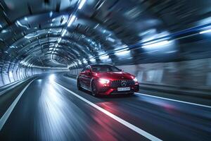 Reliability Mid size sedan driving through mountain tunnel with illuminated walls and sense of adventure ahead photo