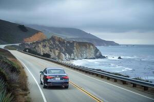 Sophistication Luxury sedan cruising on coastal highway with panoramics of the ocean and distant cliffs photo