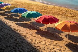 Calmness at the beach with row of beach umbrellas casting colorful shadows on the sand photo
