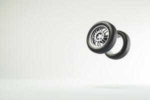Car wheels levitating against blank white background creating floating effect photo