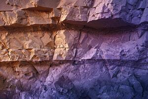 Patterns of light and shadow on canyon wall created by the setting sun background photo