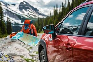 Compact crossover parked at trailhead with hiking gear and map spread out on the hood nature background photo