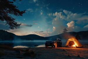 Compact Truck Parked at Lakeside Campground with Tent Pitched in Background and Campfire Burning Under Starry Sky nature background photo