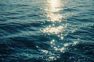 Seascape Sunlight Creating Glittering Path Across the Surface of Calm Sea nature background photo