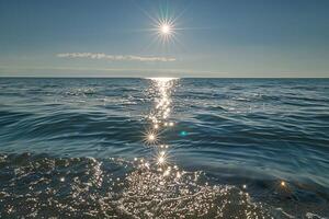Seascape Sunlight Creating Glittering Path Across the Surface of Calm Sea nature background photo
