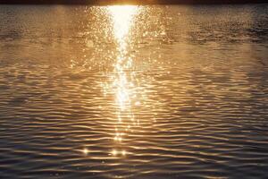 Seascape Sunlight Casting Golden Glow on the Surface of Lake nature background photo