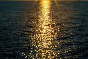 Seascape Sunlight creating shimmering path on the surface of the sea during sunset  nature background photo