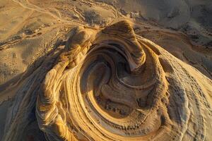 Landscape Nature Dynamic Aerial of Sandstone Formations in Desert with Swirling Patterns Carved by Wind and Erosion photo