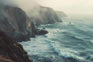 Landscape Ethereal misty morning on coastal cliffside with waves crashing against rocky shores and glow on the horizon   nature background photo