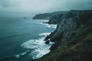 Coastal  with Gentle Waves Crashing Against Rocky Cliffs Under Moody Overcast Sky   nature background photo